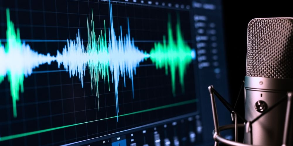 A close-up shot of a glowing audio waveform on a sleek computer monitor